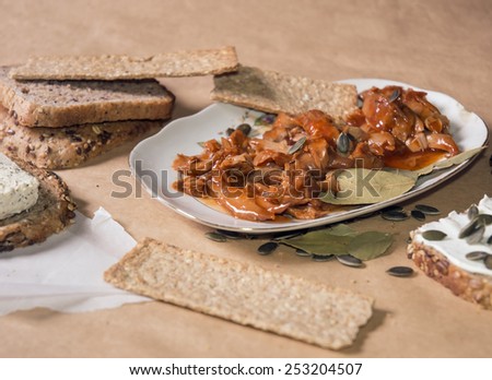 Tuna fish meal in tomato sauce with oat tiles, pumpkin seed, bread and tofu daub