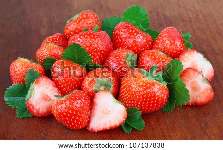 Sweet and juice strawberries on the wooden texture