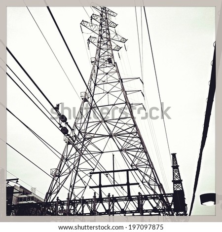 Electricity tower and wires with black and white Instagram effect filter.