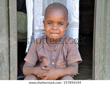 KAMPALA, UGANDA, AFRICA - CIRCA FEBRUARY 2009: Unidentified boy living in the Kampala slums circa February 2009 in Uganda, Africa. Kampala is the largest city and capital of Uganda.