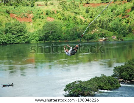 UGANDA, AFRICA - CIRCA MAY 2005: Unidentified man bungee jumping over the Nile River circa May 2005 in Uganda, Africa. Over four thousand miles in length, the Nile is the longest river on earth.