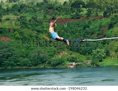 UGANDA, AFRICA - CIRCA MAY 2005: Unidentified man bungee jumping over the Nile River circa May 2005 in Uganda, Africa. Over four thousand miles in length, the Nile is the longest river on earth.