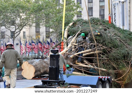 NEW YORK - NOVEMBER 12: The arrival and set up of the famous Rockefeller Center Christmas Tree in Rockefeller Center on November 12, 2010 in Manhattan, New York.