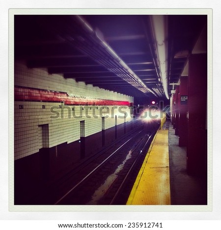 Subway car arriving underground in the New York City subway station with Instagram effect filter.