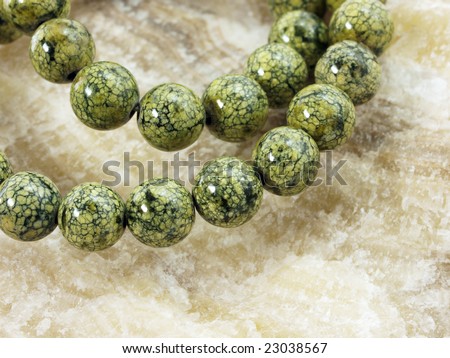 Green necklace on stone background