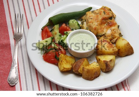Roasted chicken with sauce of a coriander and potatoes, vegetables