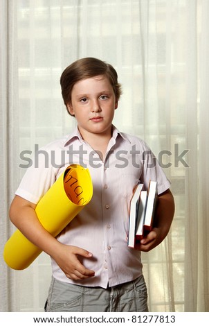 ?ute boy with books and yellow roll