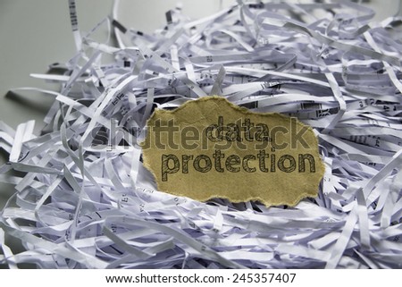 Shredded paper with piece of brown paper in the center written \