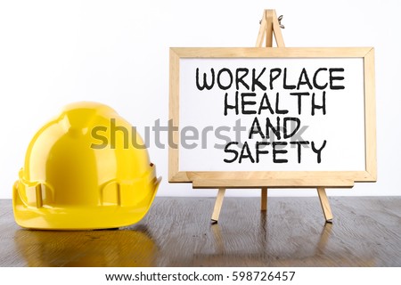 Safety helmet and white board with words Workplace Health and Safety,Health and Safety concept.