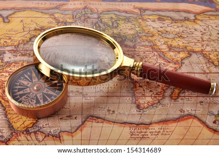 an ancient map and a magnifying glass