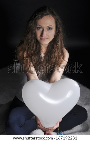 young girl gives a balloon form of heart