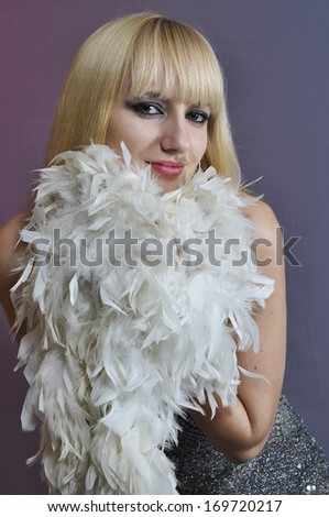girl holds a white feather boa near face