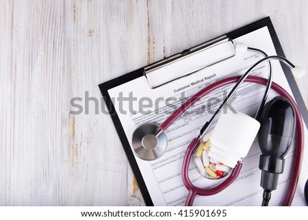 medical concept of medical report with pills and a stethoscope