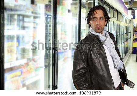 man waitting near freezer in grocery store