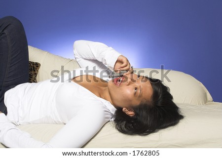 girl using cell  phone on couch