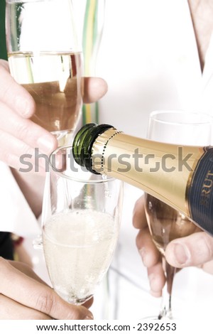 pouring champagne in glass at new year's eve