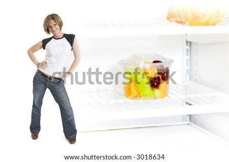 woman standing beside fruit cup in fridge