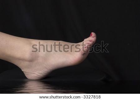 foot close up with reflection over black drop