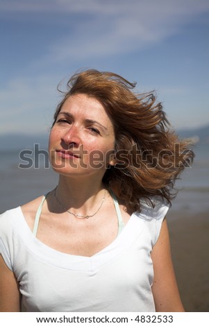 woman close up portrait with her hair in the wind