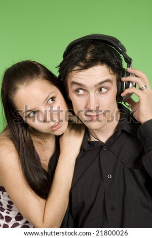 couple listening to plaisant music over green background