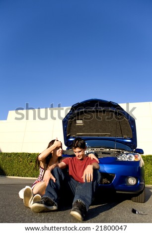 couple sitting down after car break down