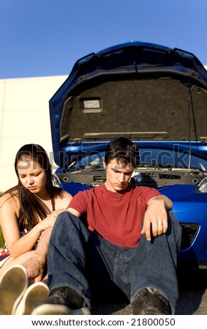 couple sitting down after car break down