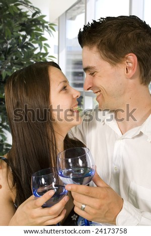 young couple drinking in bright hallway in hotel