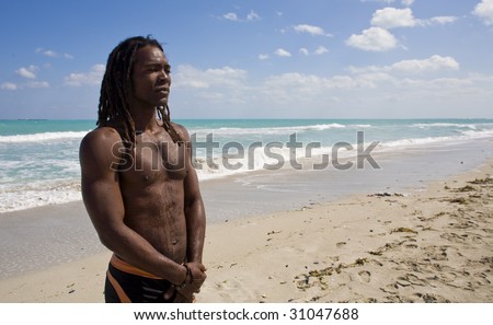 black man thinking on the beach back in the blue sea over blue sky