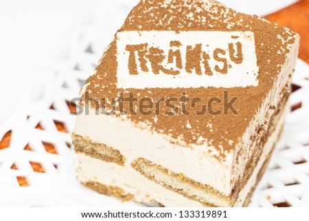 Tiramisu. Slice of tasty  tiramisu cake,  traditional Italian biscuit dessert on white plate