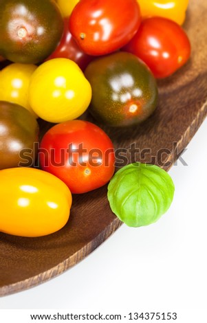 Baby plum tomatoes. Different sorts of tomatoes on white backgrund. Shallow depth of field