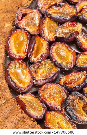 Plum tart. Plum cake with roasted cinnamon plums. Close up, macro. Above view