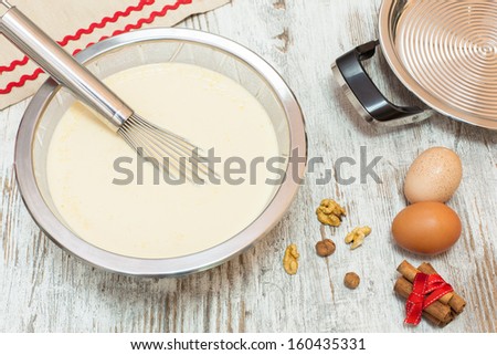 Ingredients for making pancake  batter. Batter making ingredients ready for making pancakes, on  wooden table. Viewed from above