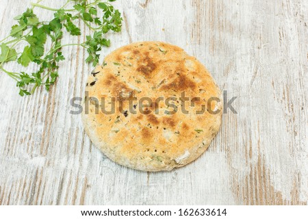 Focaccia bread, dimpled Italian flat bread, flavored with olive oil , herbs, onion, olives