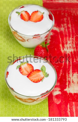 Strawberry Mousse. Strawberry mousse in a glass decorated with sliced strawberries for a dessert.  Macro, selective focus