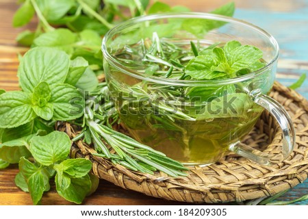 Herbal tea. Rosemary Mint Tea with fresh rosemary and mint leaves. Phytotherapy plants and medical herbs. Macro, selective focus