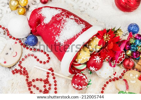 Christmas Cookies. Sweet Sugar  Santa Hat, decorated with festive royal icing and Christmas cookies on festive table. Selective focus