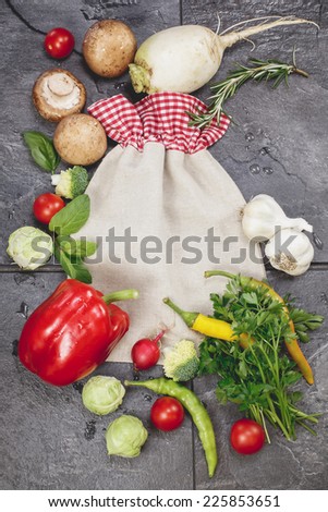 Cooking  concept with seasonal  vegetables. Vegetables and spices vintage border and vegetable storage bag. Cooking concept. Copy space composition