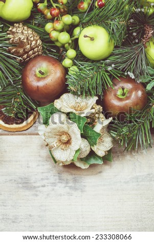 Christmas decoration. Green decoration with fruits. Done with soft vintage retro filter. Close up