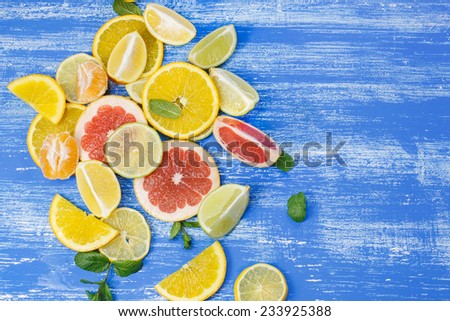 Set of sliced citrus fruits. Different sliced juicy citrus fruits on rustic wooden table