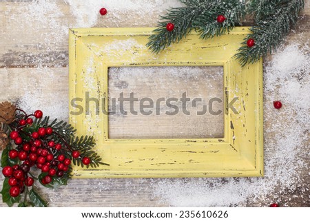Blank photo frame and Christmas decoration. Vintage frame and Christmas decoration on old rusty background.  Copy space for your text.