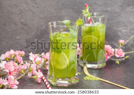 Matcha Mint Iced Tea. Healthy Iced Matcha Tea with lime, ginger and mint  with matcha powder on side. Macro, selective focus