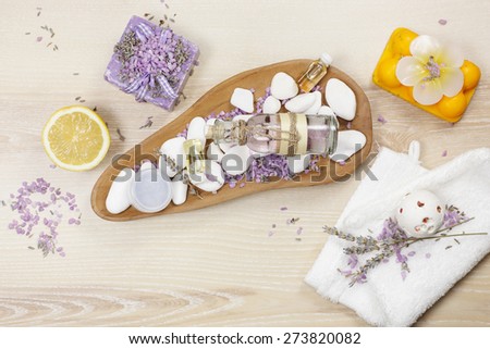 Lavender and lemon aromatherapy. Natural handmade lavender oil, soaps with bath salt, foaming bath bomb, lemon and lavender on wooden background
