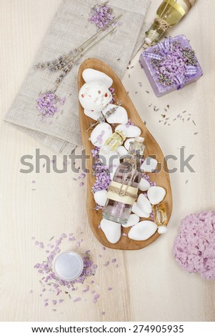 Lavender spa set on linen. Various products, facial and body massage oils for spa treatment