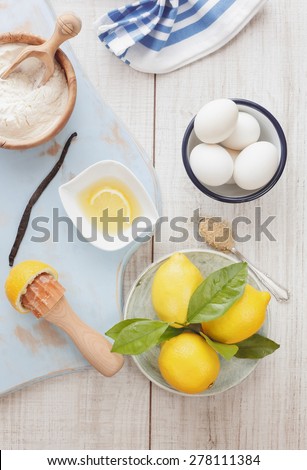 Lemon cake. Ingredients for lemon cake on wooden table, vintage style, top view. Natural light