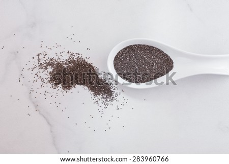 Chia seeds. Raw whole  chia seeds in  ceramic spoon. Natural light