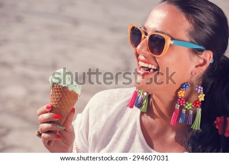 Happy woman enjoying in  matcha mint chip ice cream.  Focus on the ice cream