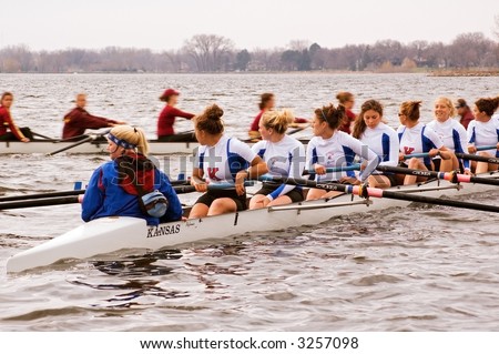 Kansas University women\'s rowing team watches as the University of Minnesota women\'s rowing team goes past - motion blur - April 21, 2007 at Minnesota