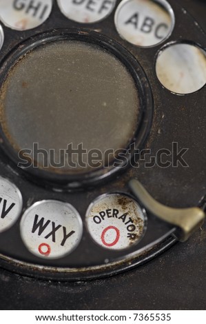 Operator Please - Rotary Phone- dusty beat up rotary dial phone detail - tight depth of field - focus on operator/0