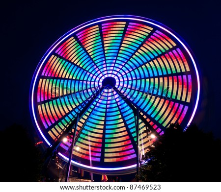 Bright Multi-Colored Spinning Ferris Wheel - patterns created by lights on wheel