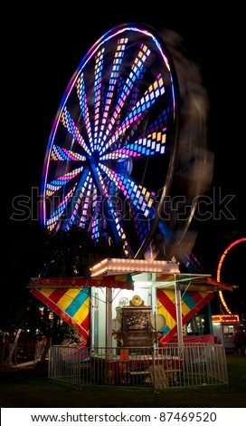 Colorful Spinning Ferris Wheel and Antique Fairground Organ - ferris wheel spins with antique fairground organ in foreground